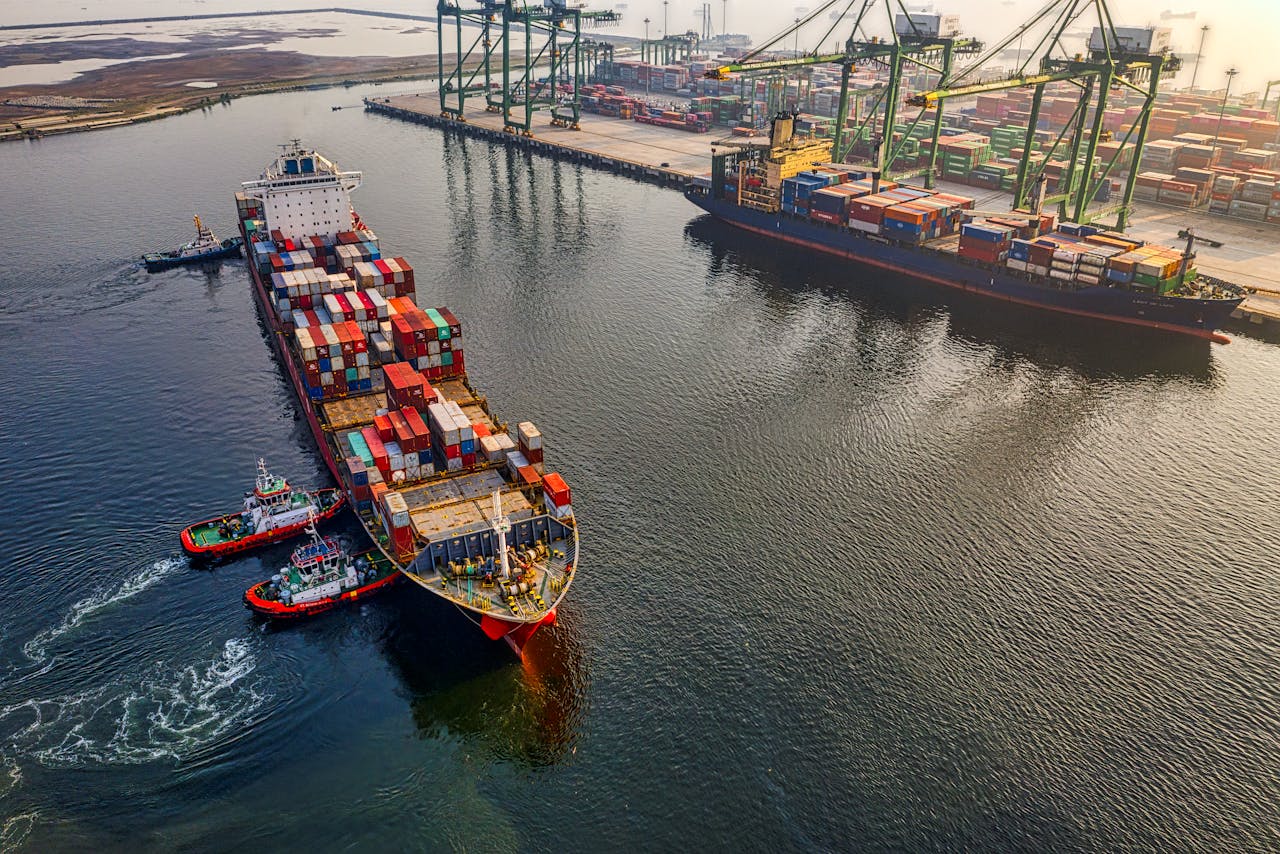 The Art of Drawing Readers In: Your attractive post title goes here Aerial shot of cargo ships and cranes at North Jakarta port, showcasing global shipping and logistics.